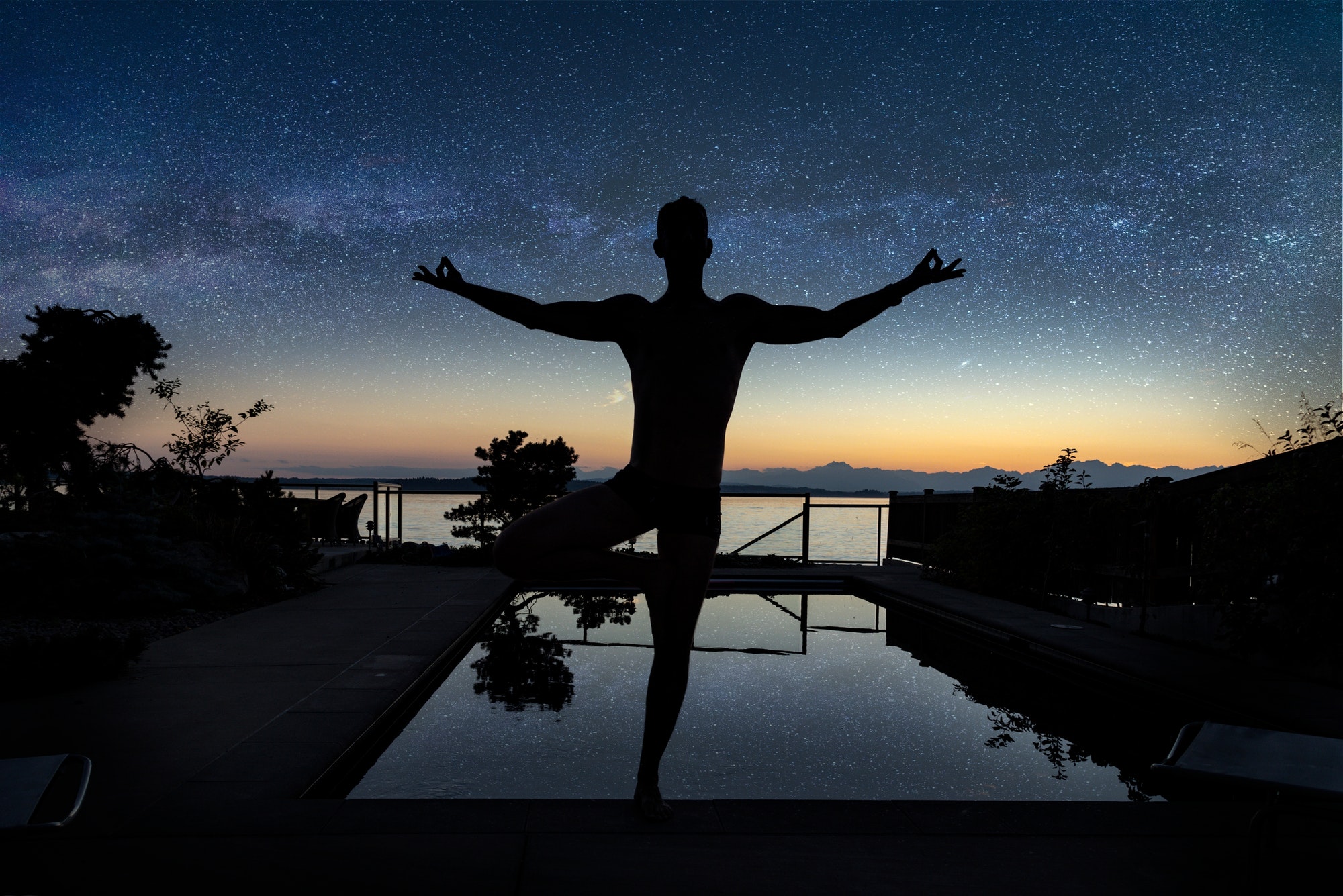 Yoga zen pose under starry night sky